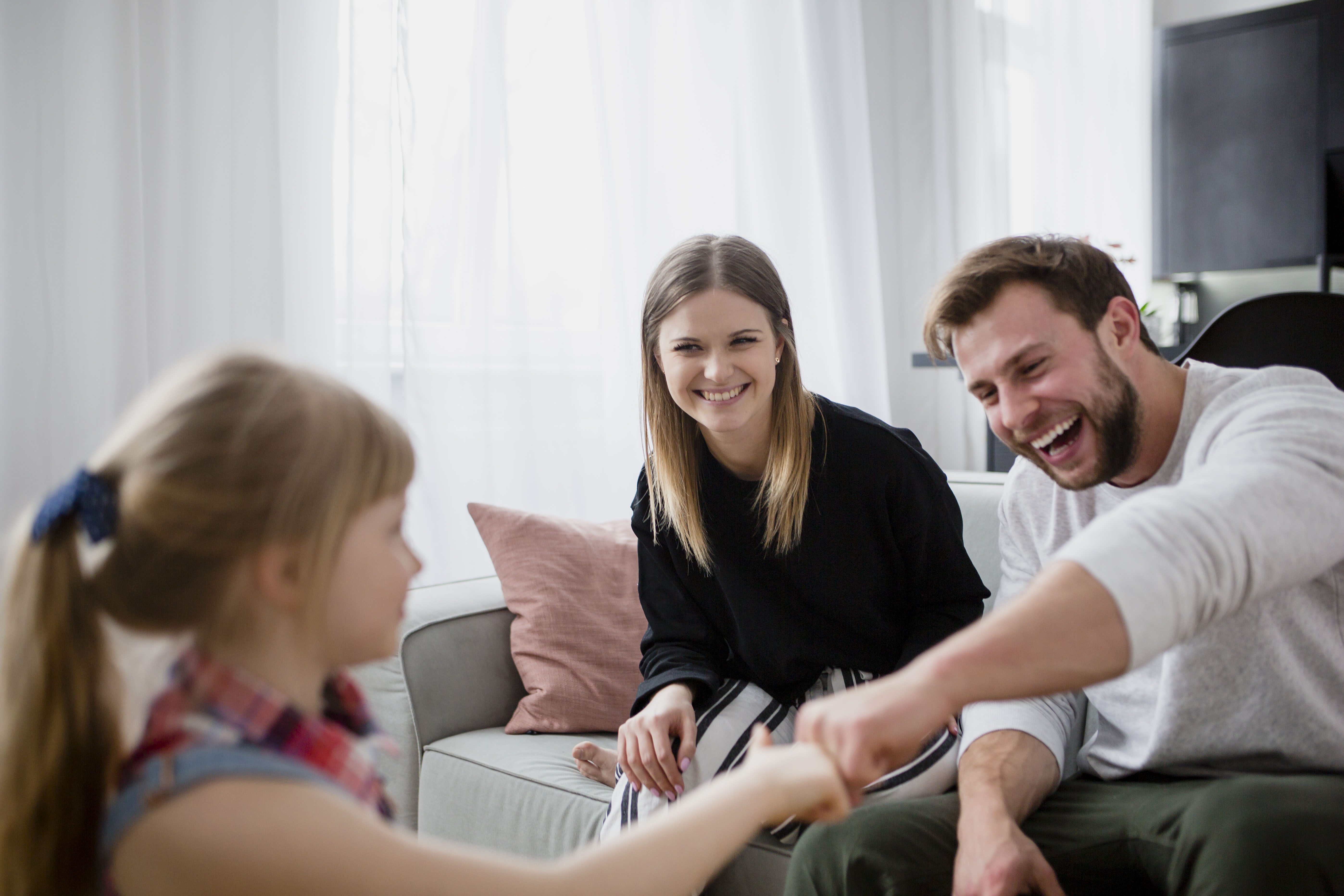 girl-bumping-fists-with-parents